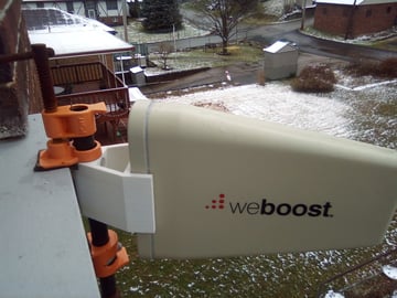 This removable cell phone booster mount for a weboost cell phone booster improves cell phone reception and is used on a windowsill