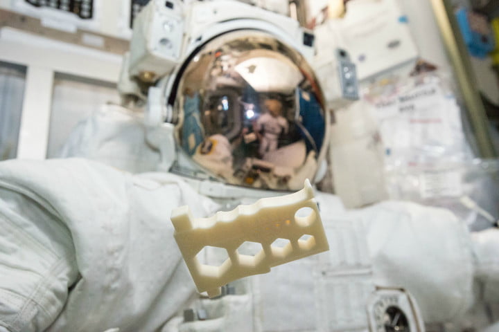 An Astronaut holding a 3D printed tool