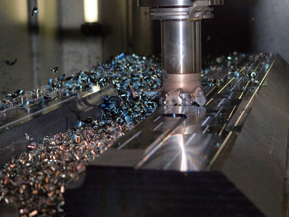 A CNC machine removes metal.