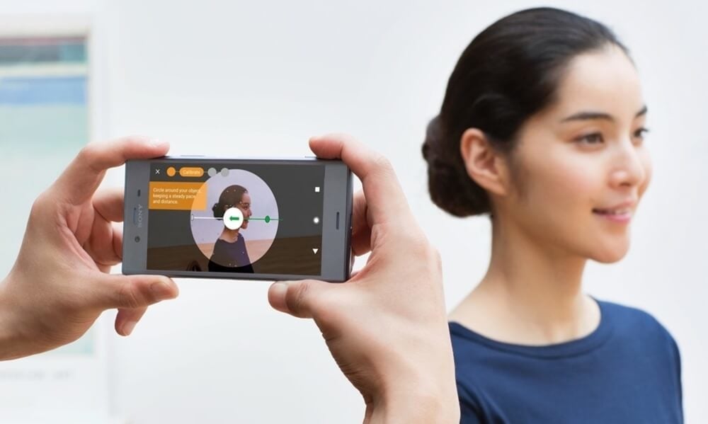 A person scanning a girl's face with a smartphone.