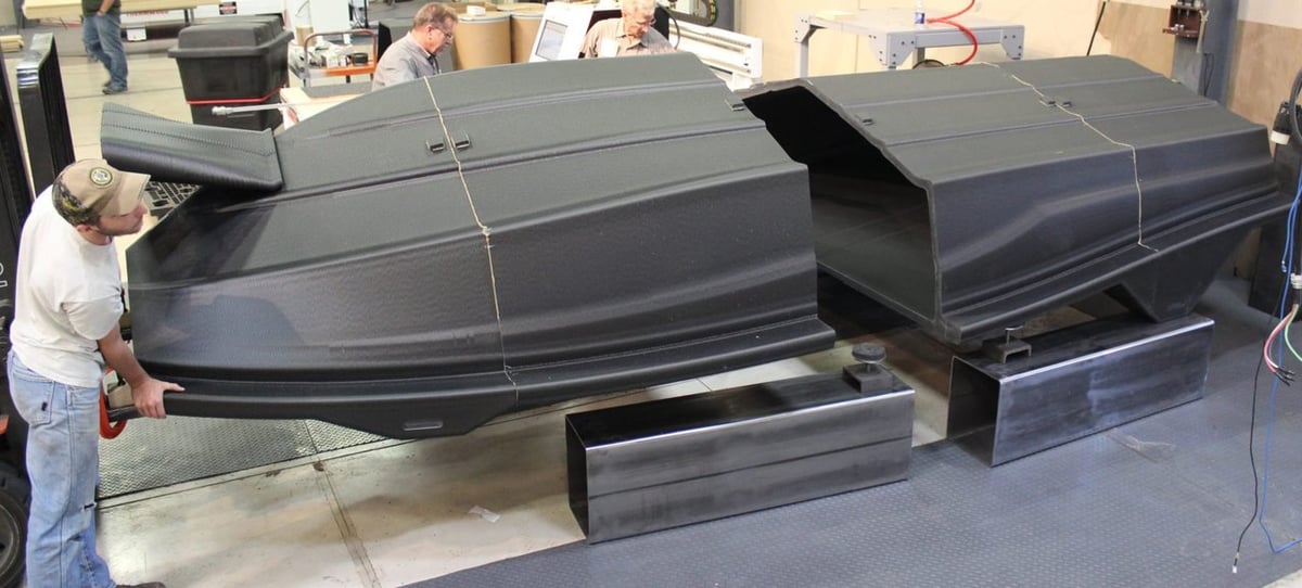 Gluing pieces of a life-size 3D printed boat hull.