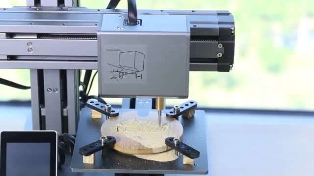The Snapmaker using its CNC function on a carving job