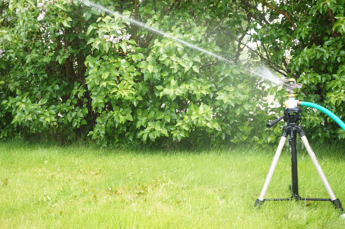 The combination of a tripod and a sprinkler system makes watering your yard easy