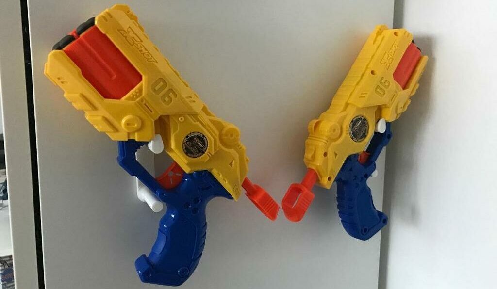 Hot glue is more than enough to hold these light Nerf guns