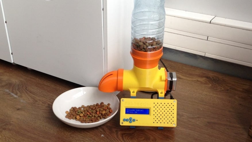 This feeder system automatically dispenses a certain amount of food from its supply above