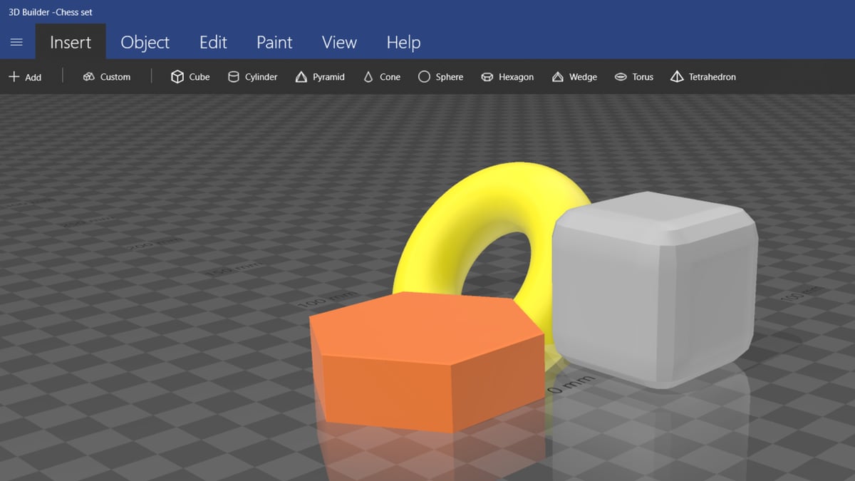 A hexagon, a torus, and a custom rounded cube all added through the Insert tab