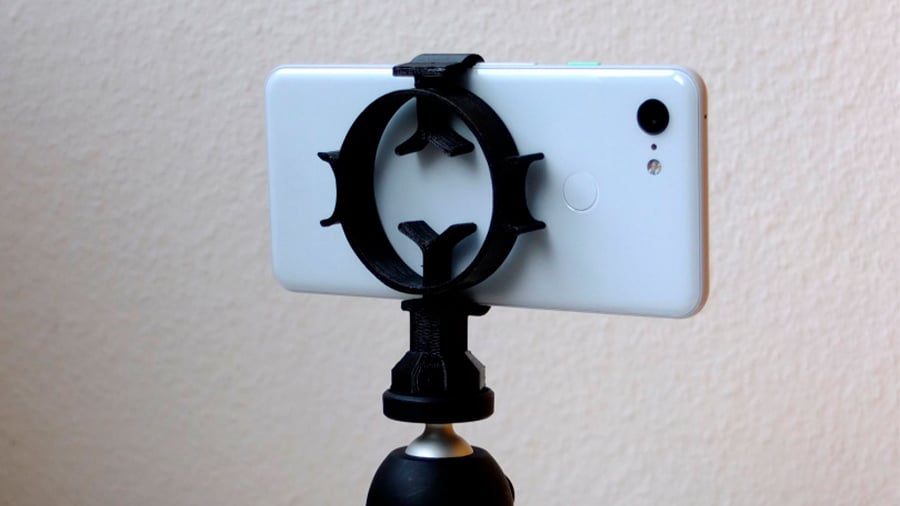 This tripod mount uses the flexibility of the central ring to clamp and hold smartphones of various sizes