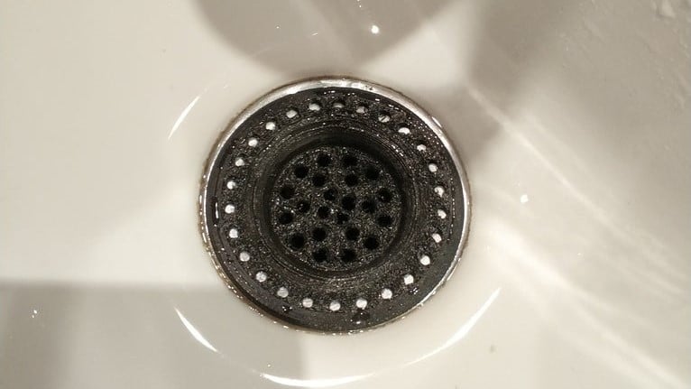 This grate is meant to stop hair from clogging your shower drain