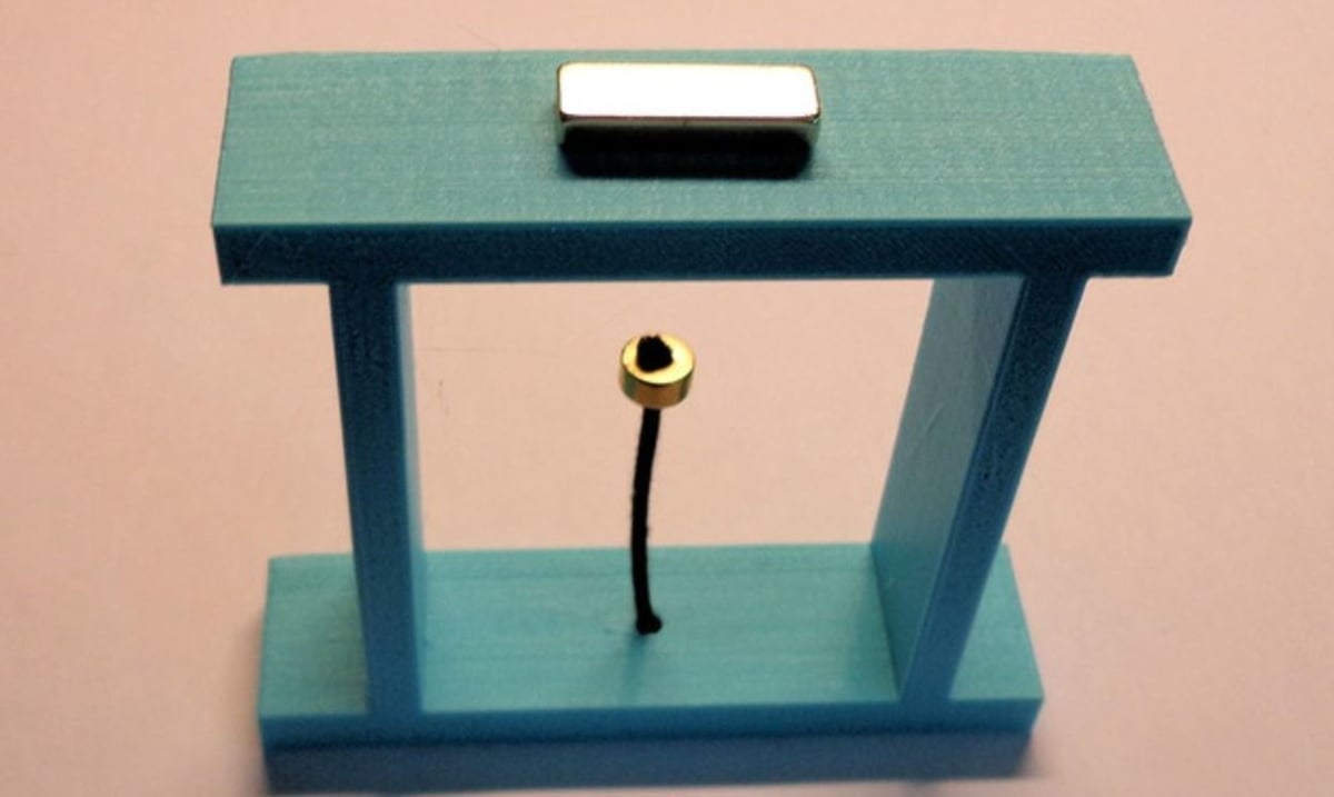 The two magnets attract and the rope holds the smaller one down, so the smaller magnet floats in mid air