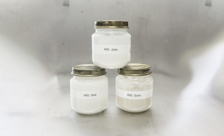 Jars of homemade ABS juice, glue, and slurry