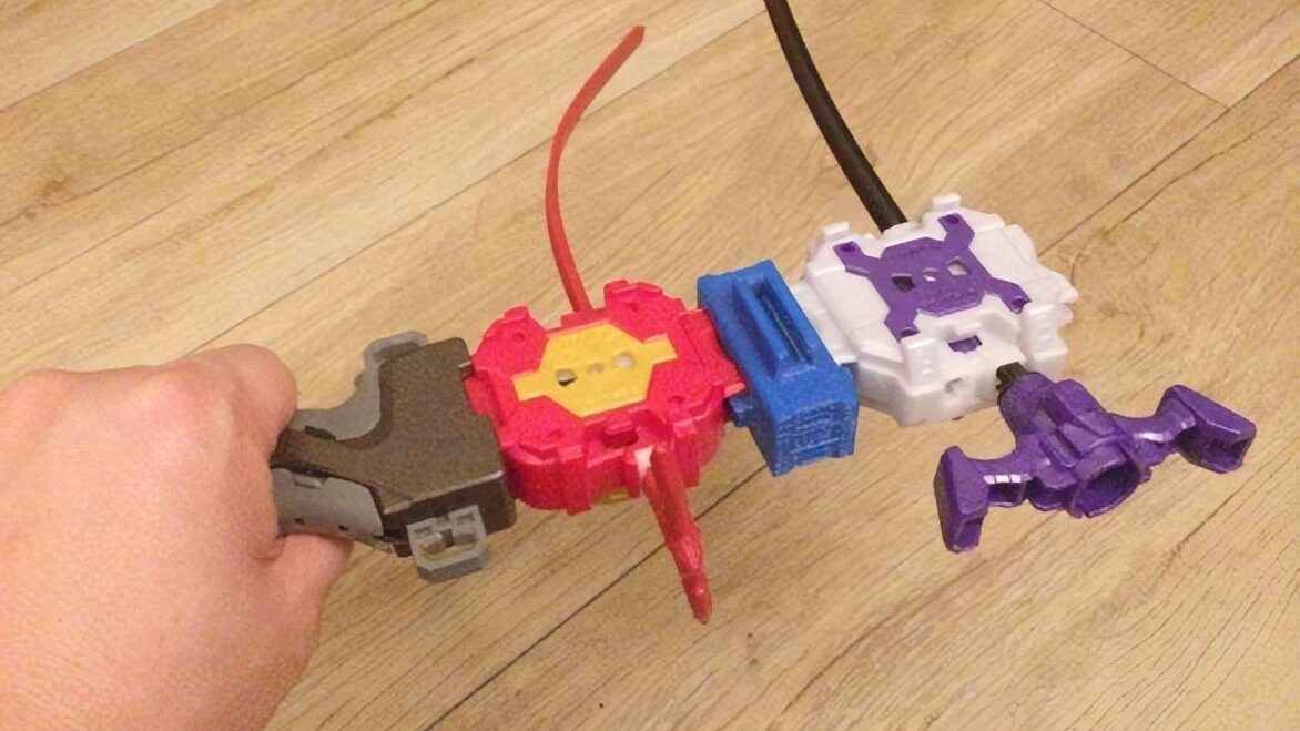 Two Beyblade launchers attached together using a 3D printed adapter