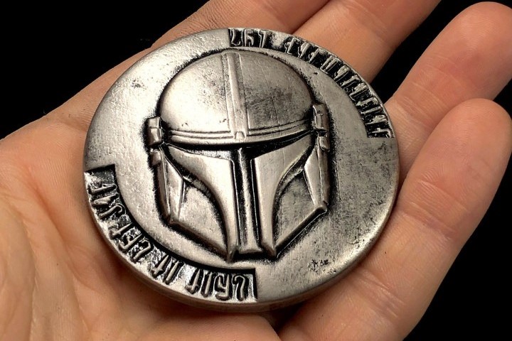 Show off the helmet with this cool Mandalorian coin