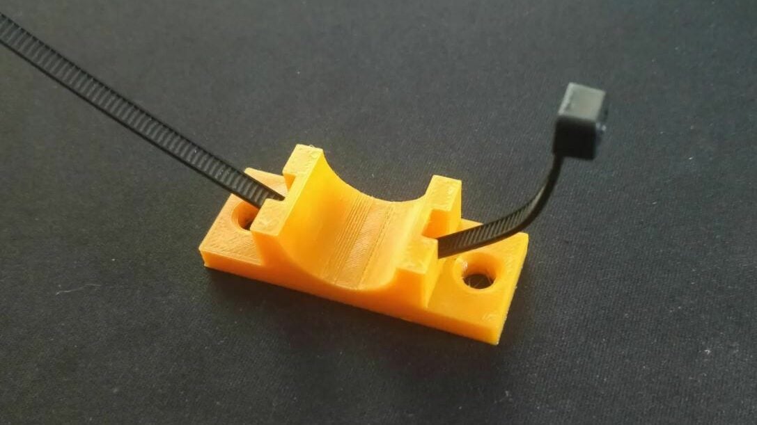 You can loop a zip-tie through this model to hold your cables