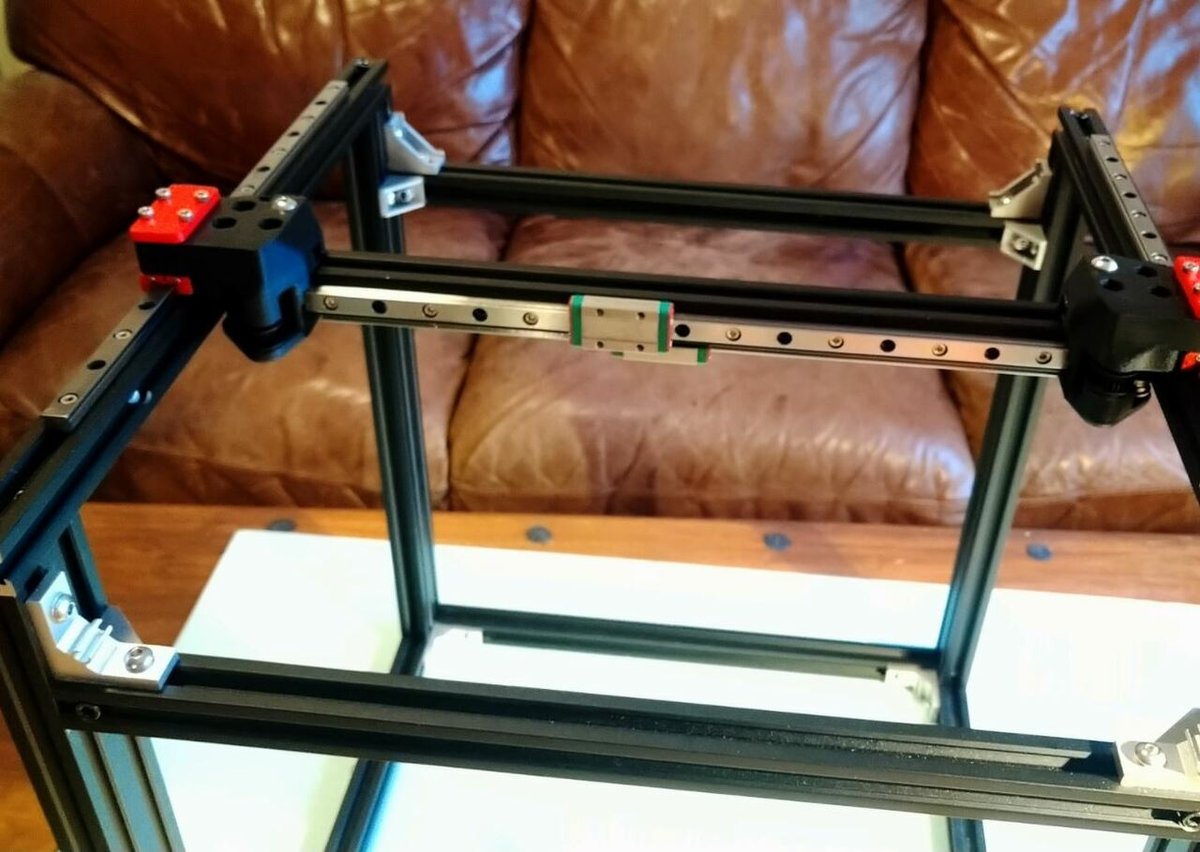 Adding linear rails to every axis of a printer can be expensive