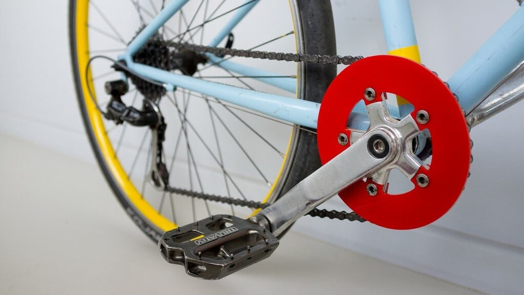 You can 3D print this chain guard by adding height with 3D modeling software