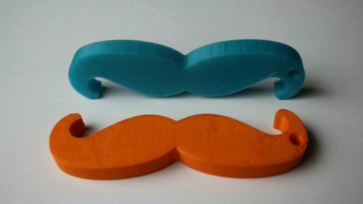 A couple of printed mustaches ready for their keyrings