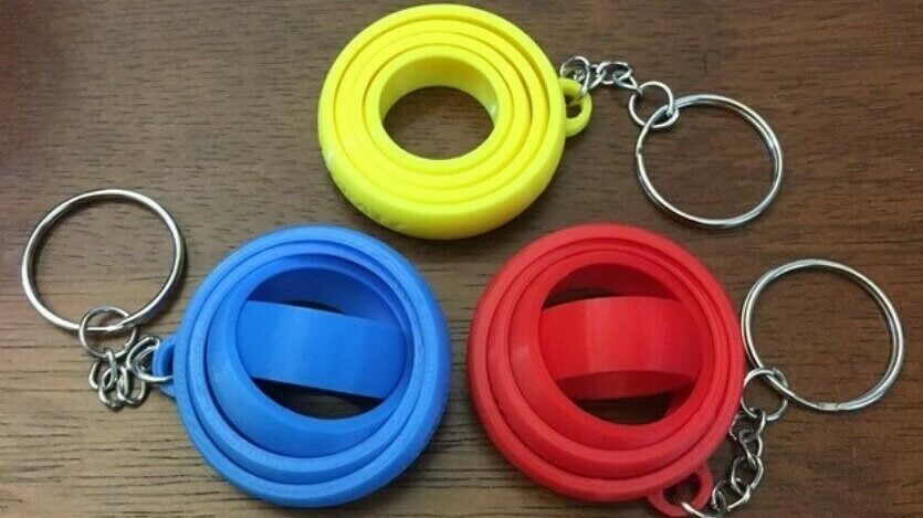 A colorful collection of three gyro keychains that would make for nice gifts
