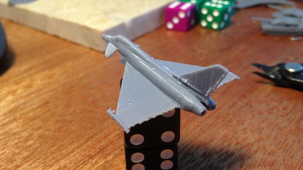 A mini-Eurofighter Typhoon with dice for scale