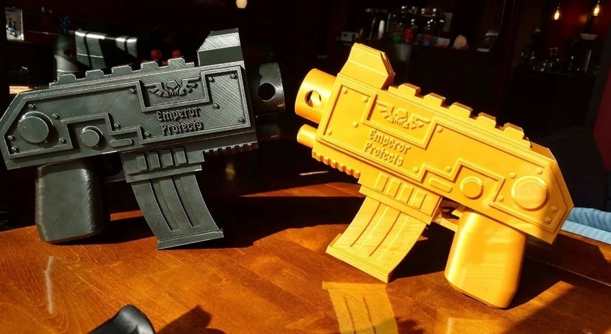 Two Warhammer bolt buns printed with yellow and black PLA filaments