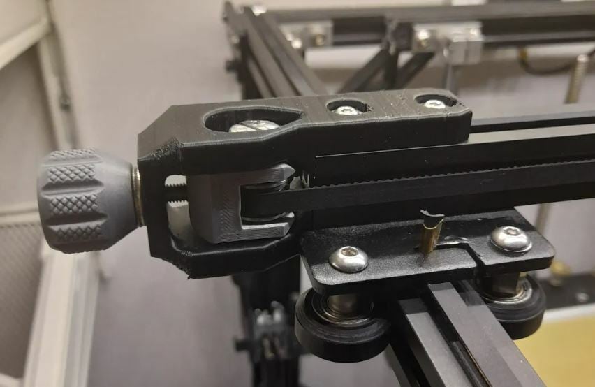 This adjustable belt tensioner is made of a few 3D printed parts, some screws, and the printer's stock bearings