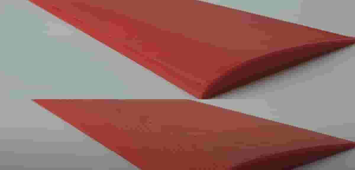 The top object was printed with non-planar 3D printing, while you can clearly see the stair-casing on the bottom print