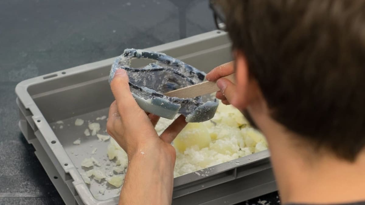 Manually removing the remaining support material.