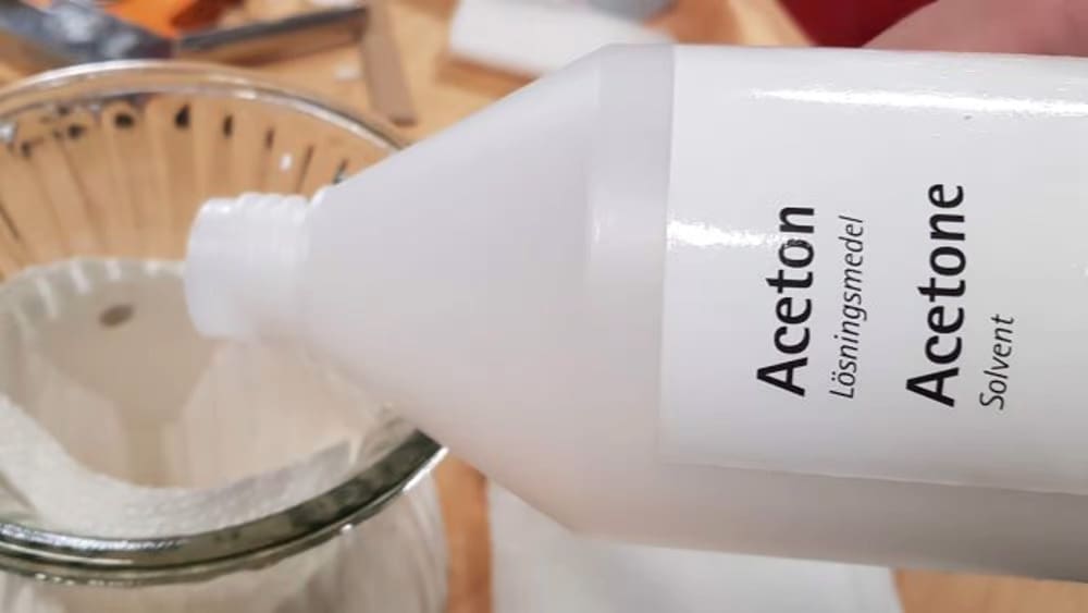 Carefully pour the acetone into the container to soak the paper towels