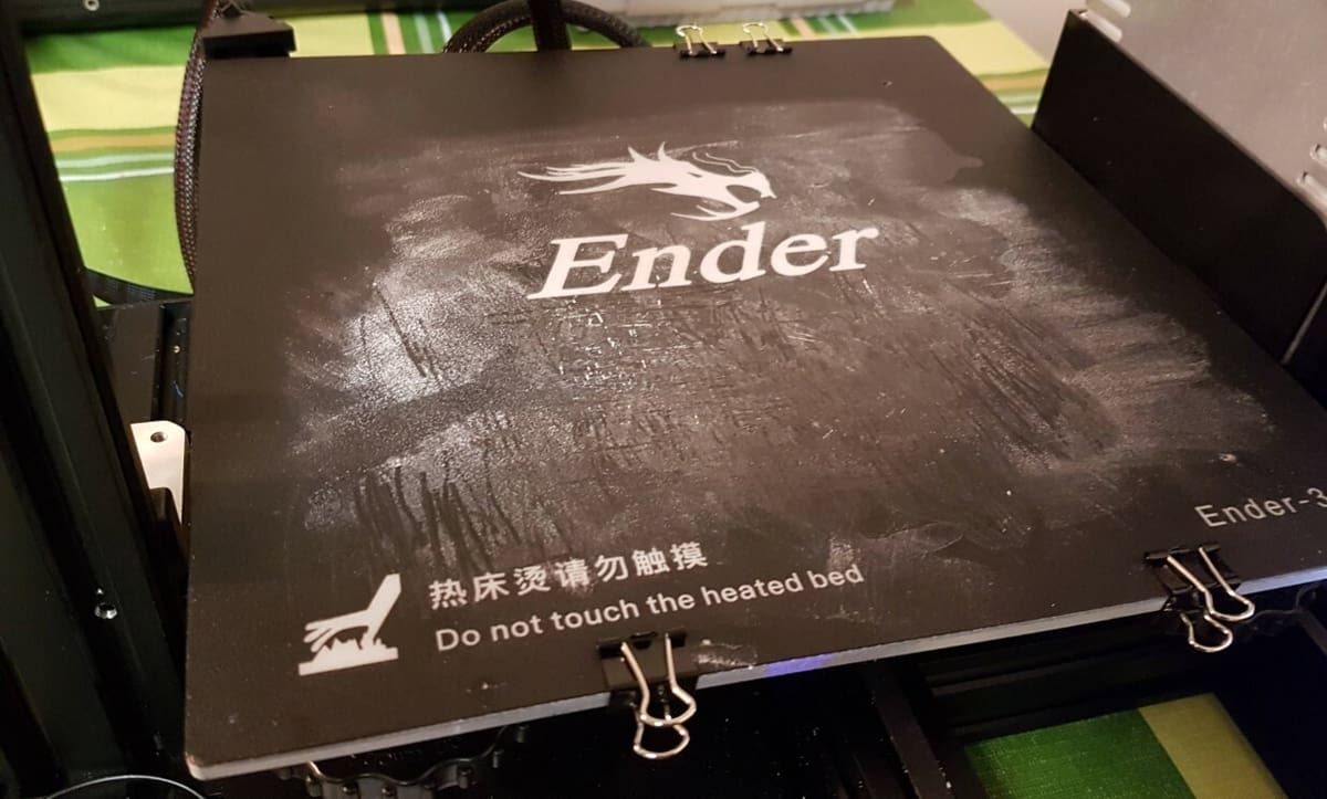 Using too much acetone will leave a white residue on the surface of your print bed